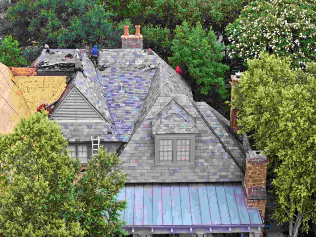 Drone view of slate roof repair in progress by national roofing experts